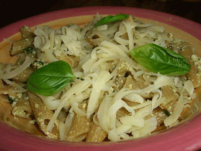 Spinach and ricotta pasta with cheese and basil on top