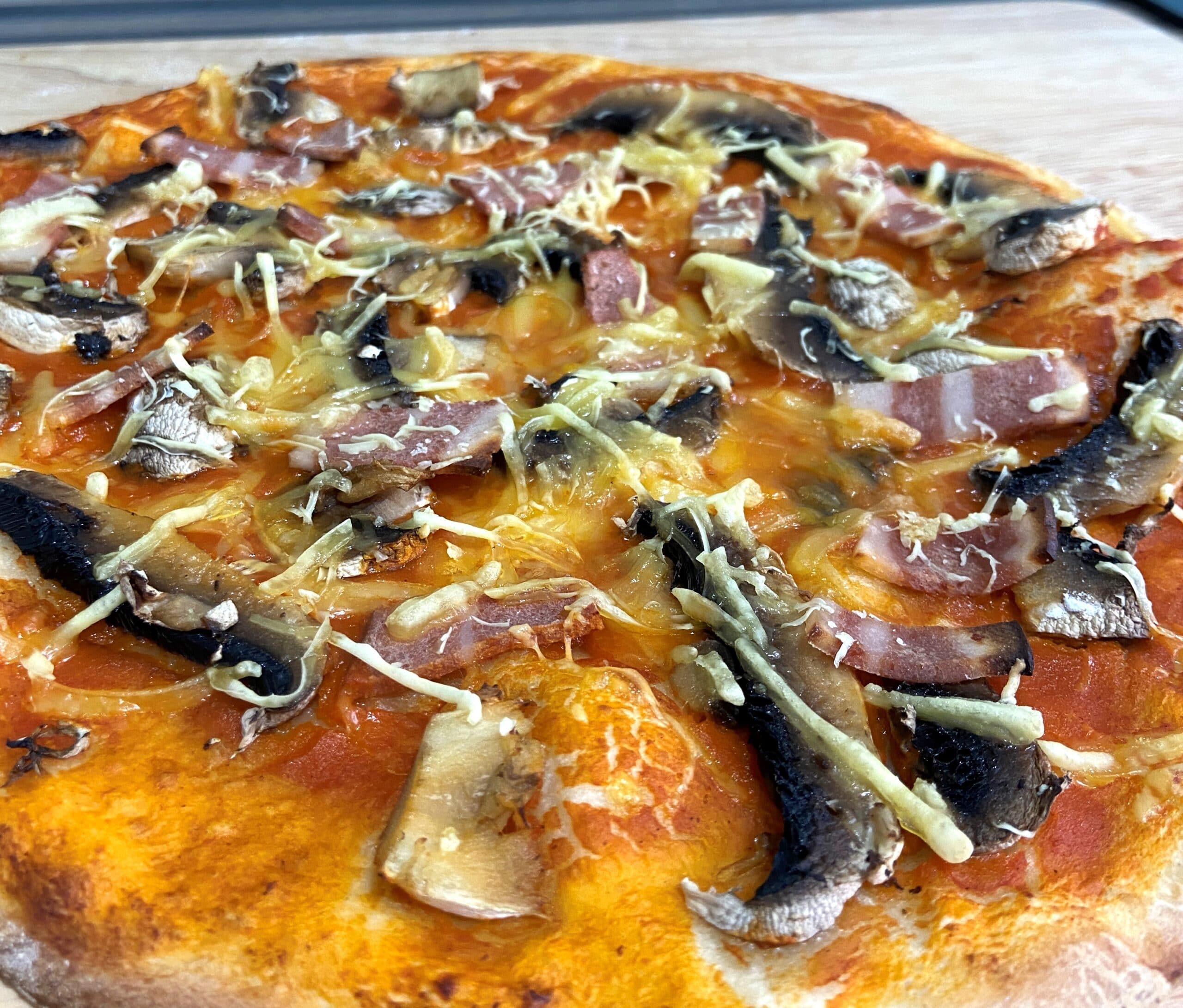 pizza with mushrooms, vegan bacon and vegan cheese